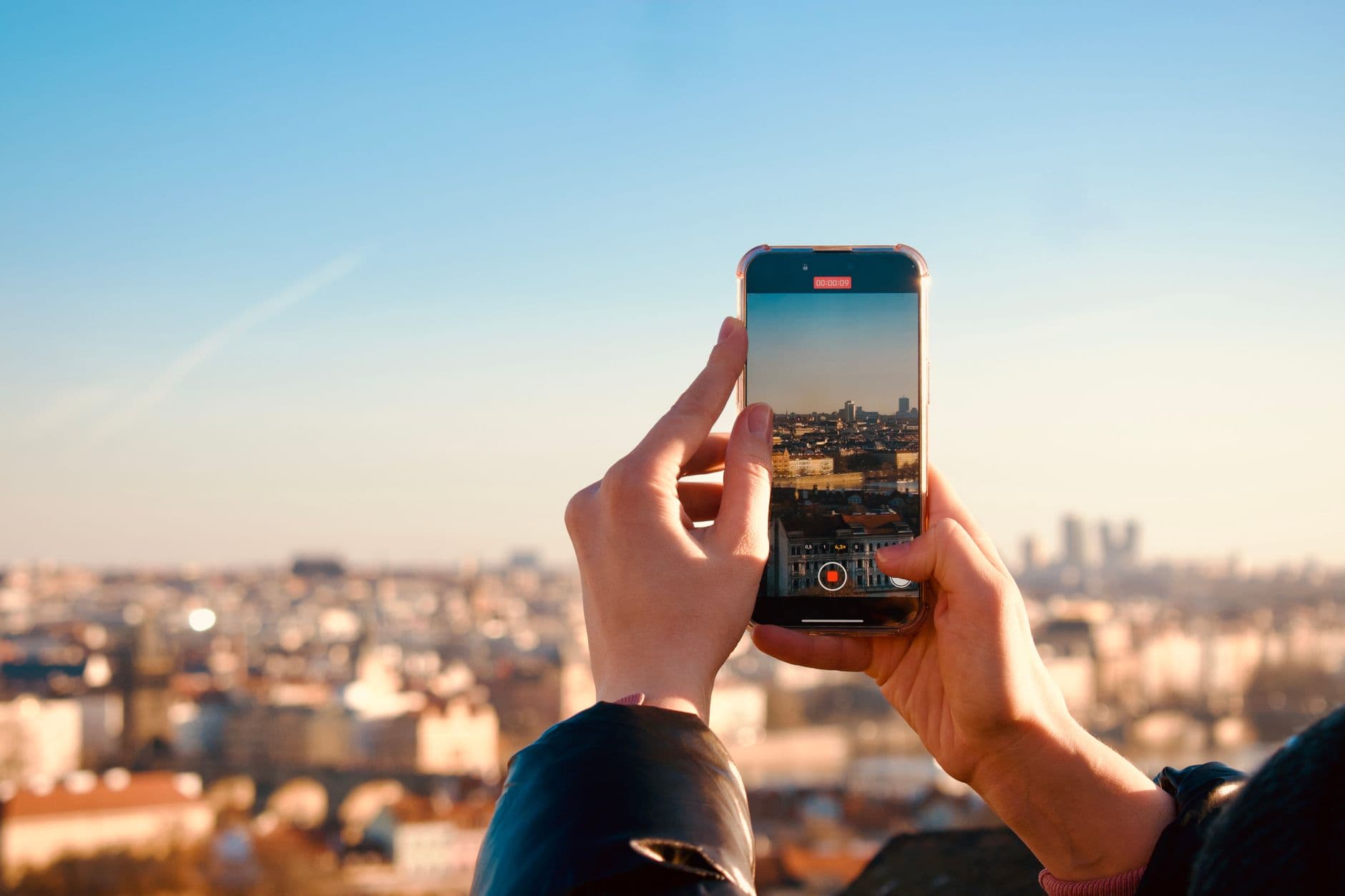 A person holding an Honor phone with a cityscape in the background, suggesting travel connectivity.