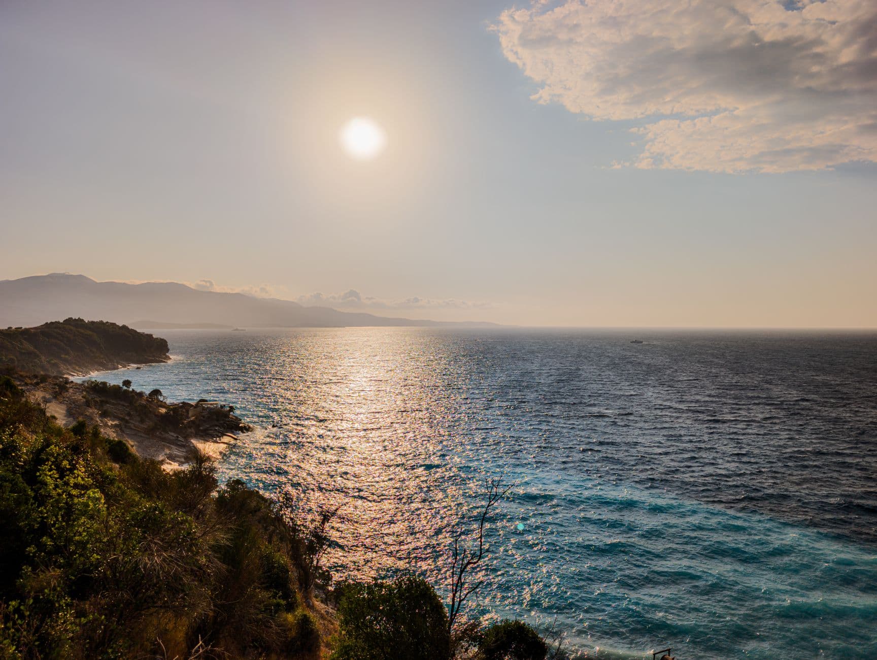Turquoise waters and white sand beach of Ksamil, Albania, with small islands in the distance.