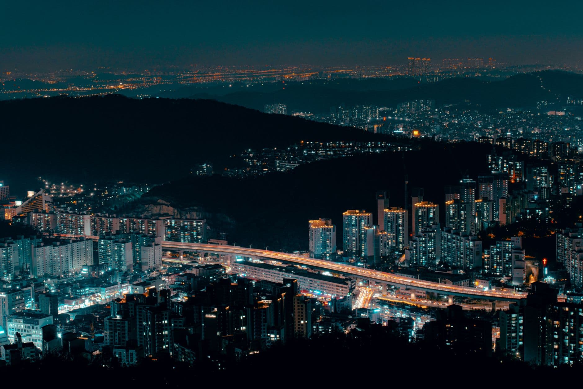 Neon-lit Seoul street at night with signs and pedestrians, illustrating connectivity for a Korea eSIM