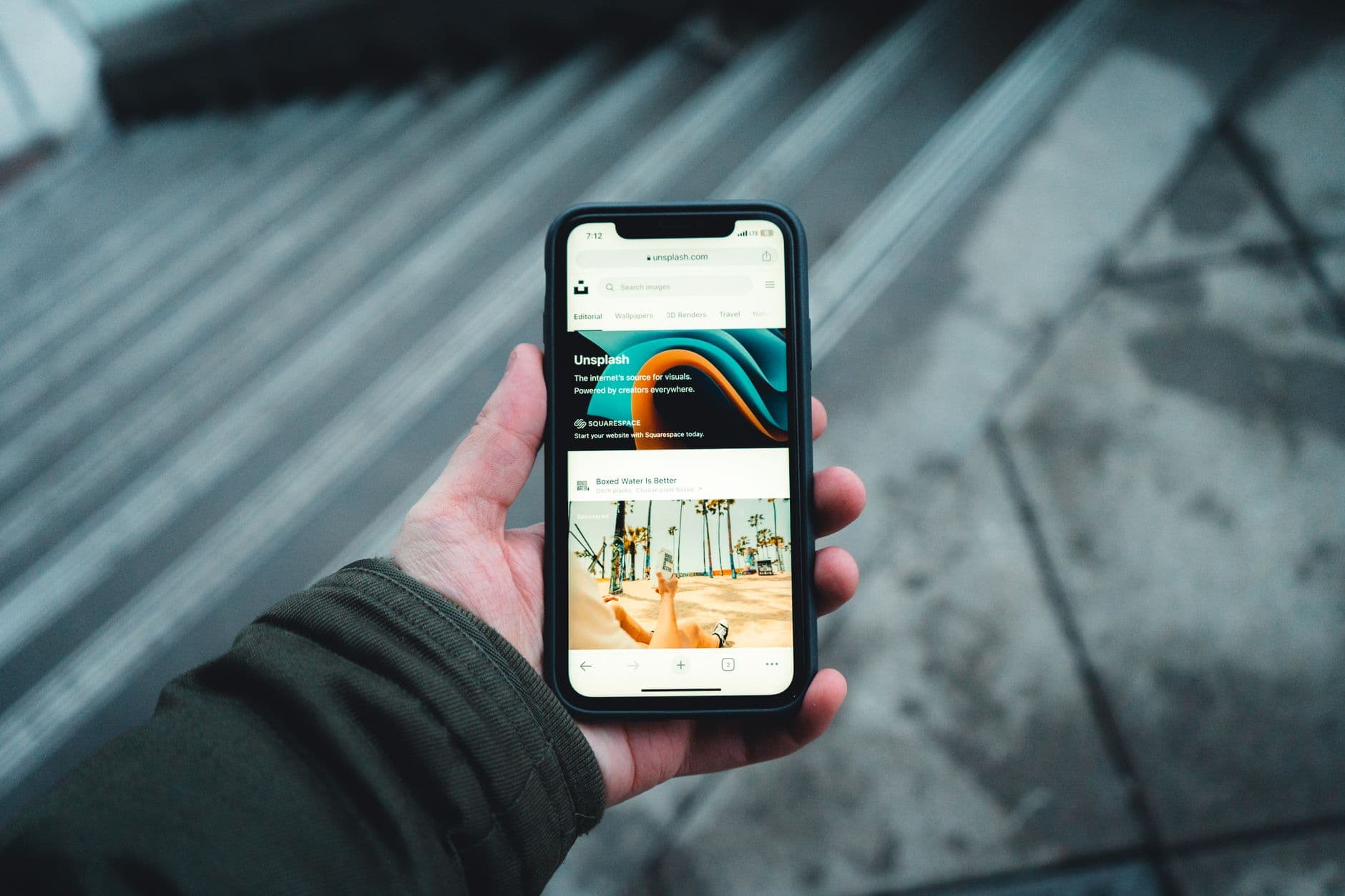 A person's hands holding a new smartphone and an old smartphone side-by-side, likely in the process of transferring data or setting up the new device.