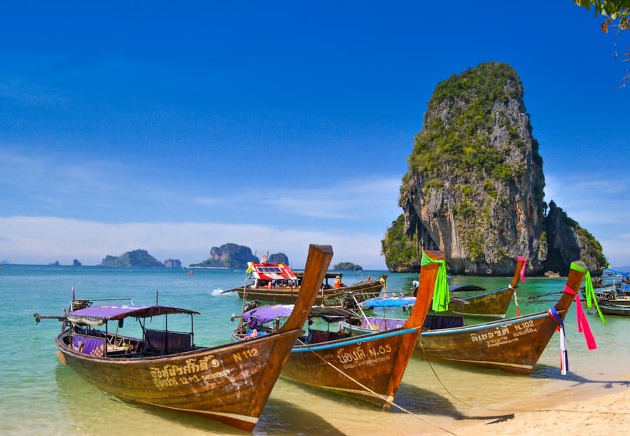 Longtail boats on a turquoise bay in Krabi, Thailand