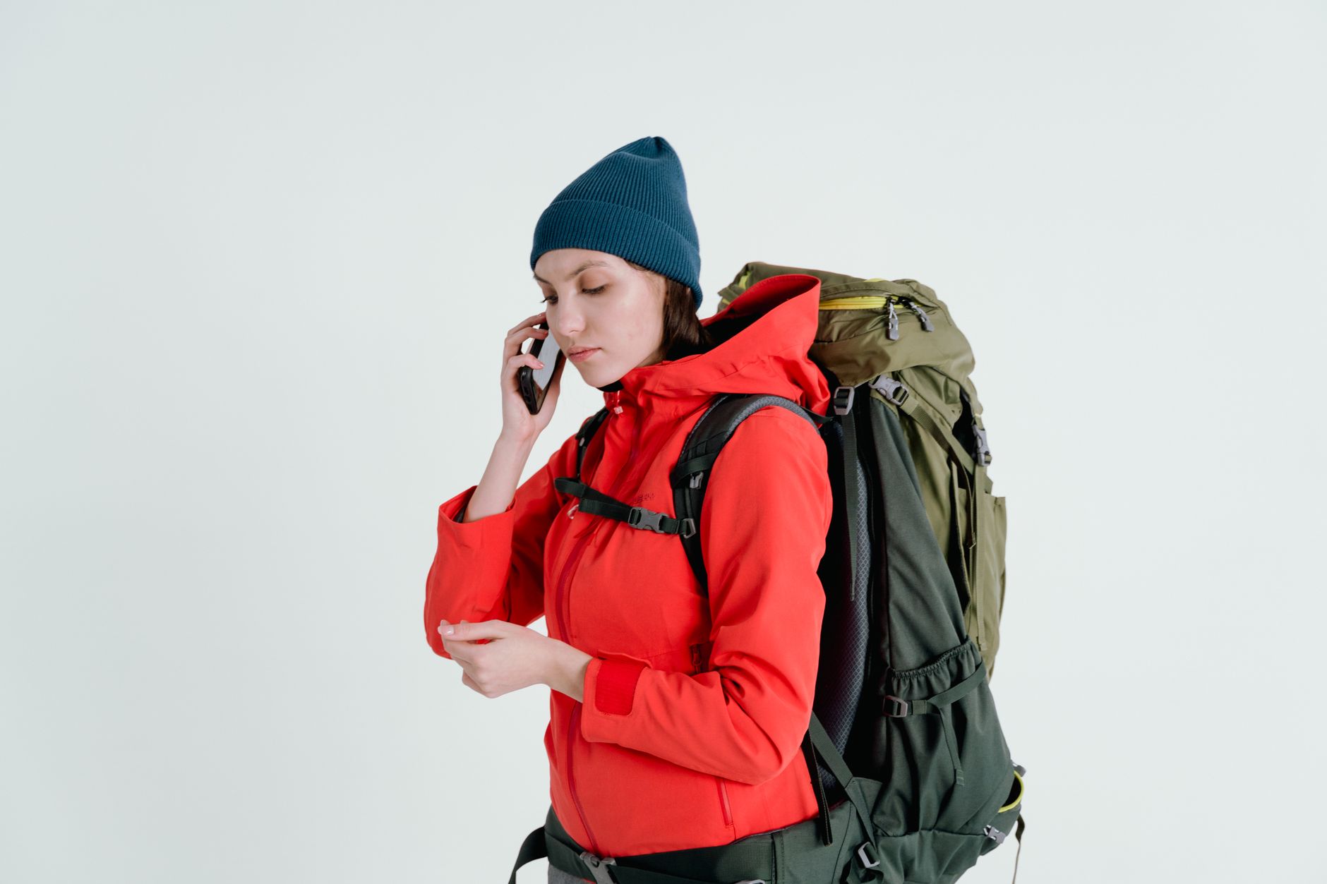 A backpacker checking their phone on a trip, illustrating a Nomad eSIM alternative.