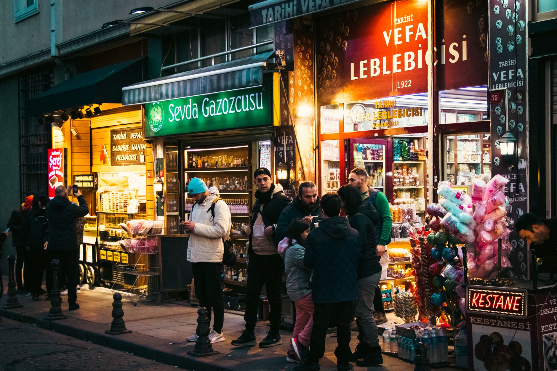 A bustling street market in Istanbul, with vendors selling fresh produce, spices, and Turkish delights under colorful awnings.