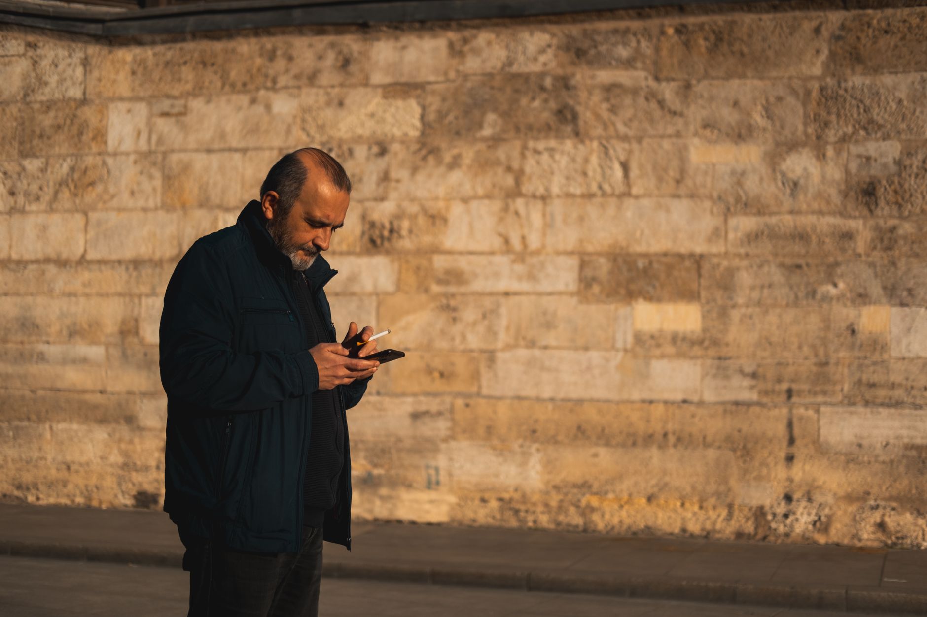 A man in a foreign city checking his phone with a puzzled expression, trying to diagnose slow internet.