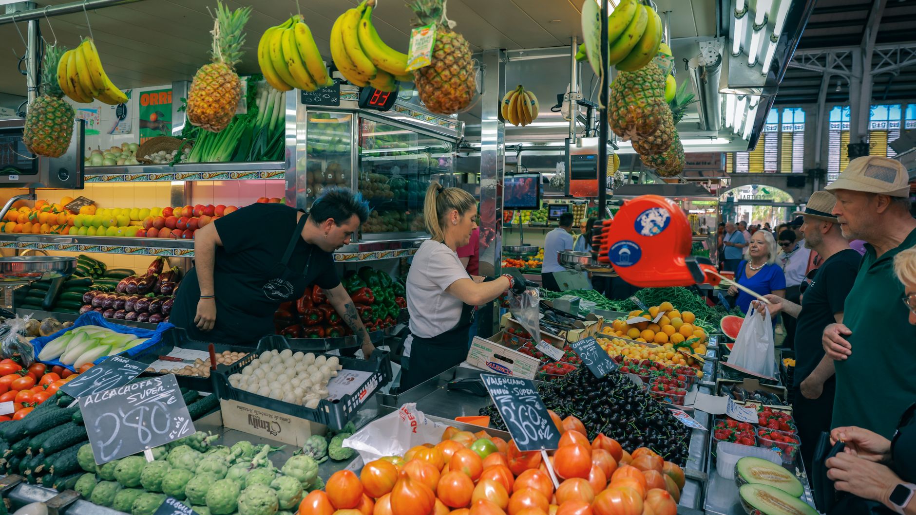 A colorful stall at Mercado dos Lavradores in Funchal, Madeira, displaying a wide variety of tropical fruits.