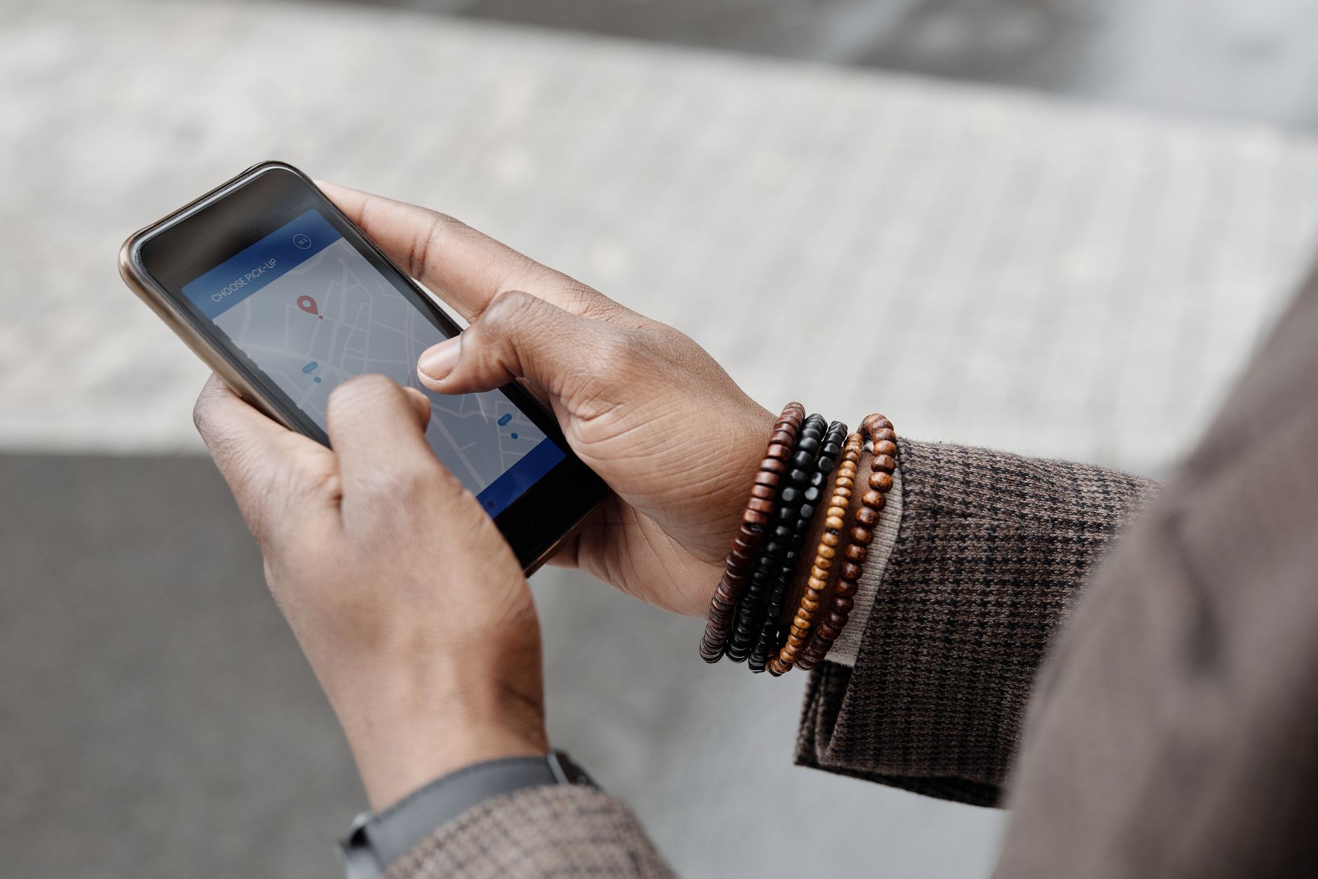 A person's hands holding a smartphone, displaying a map application with an option to download a region for offline use.