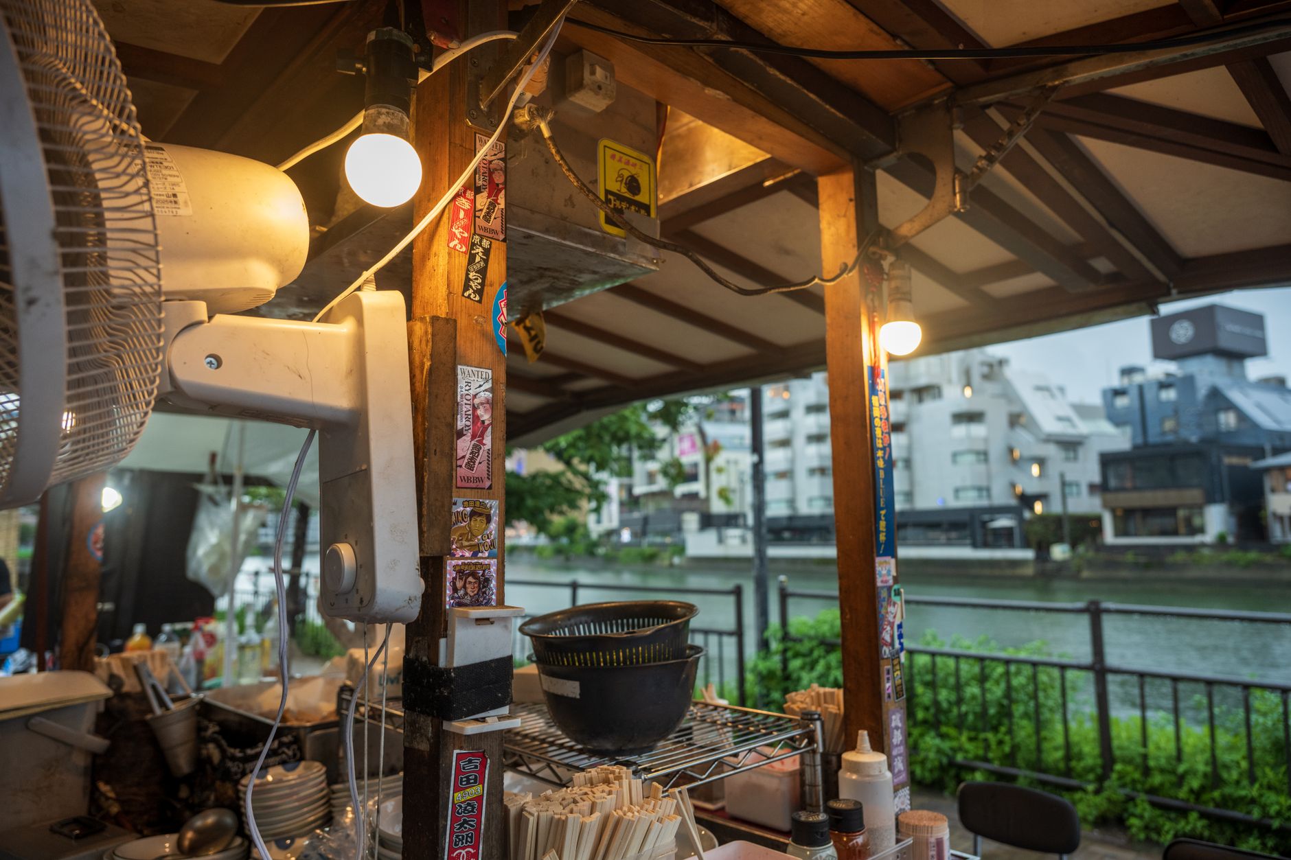 A brightly lit Japanese ramen vending machine with various ramen options and prices.