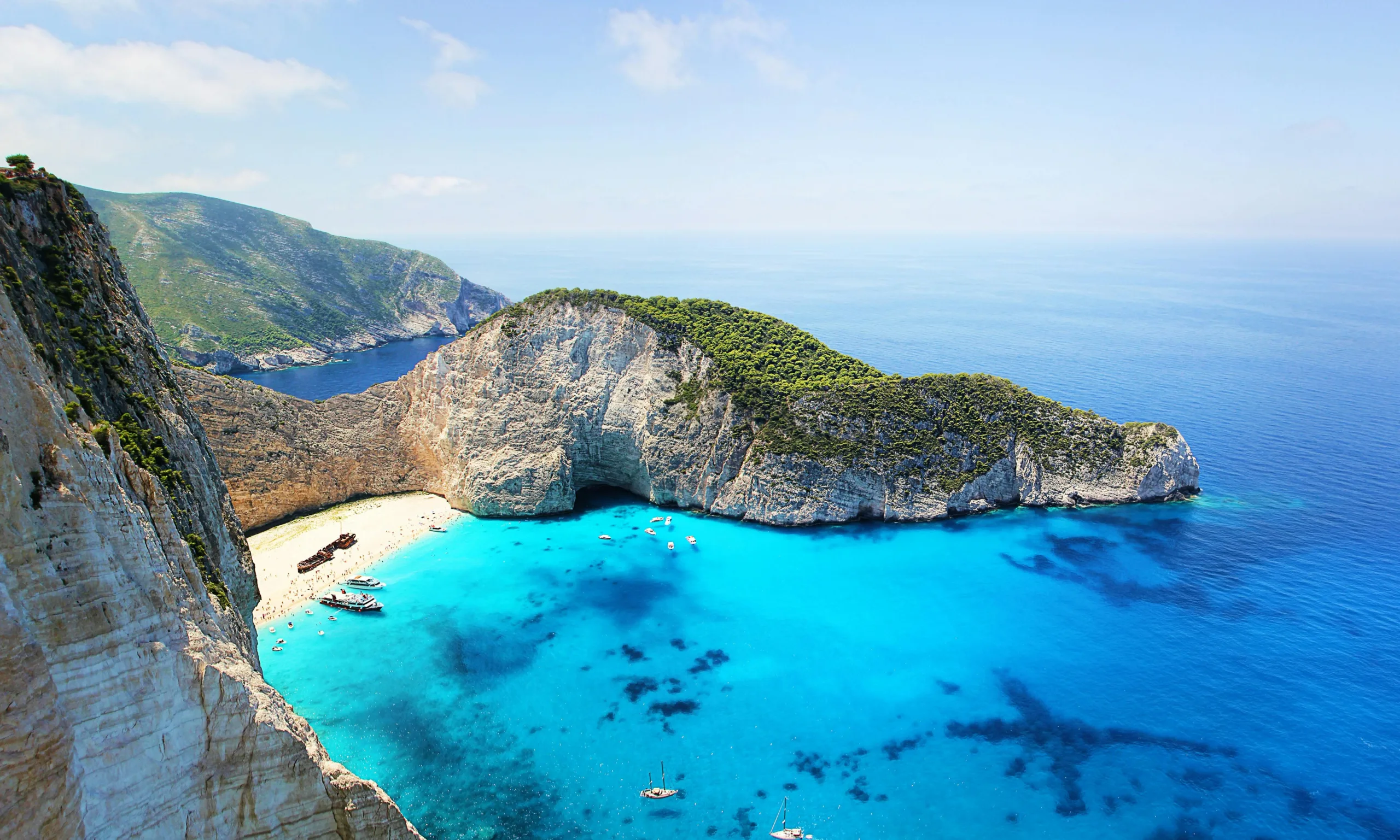 Navagio Beach Zakynthos Greece with shipwreck, turquoise water, and limestone cliffs