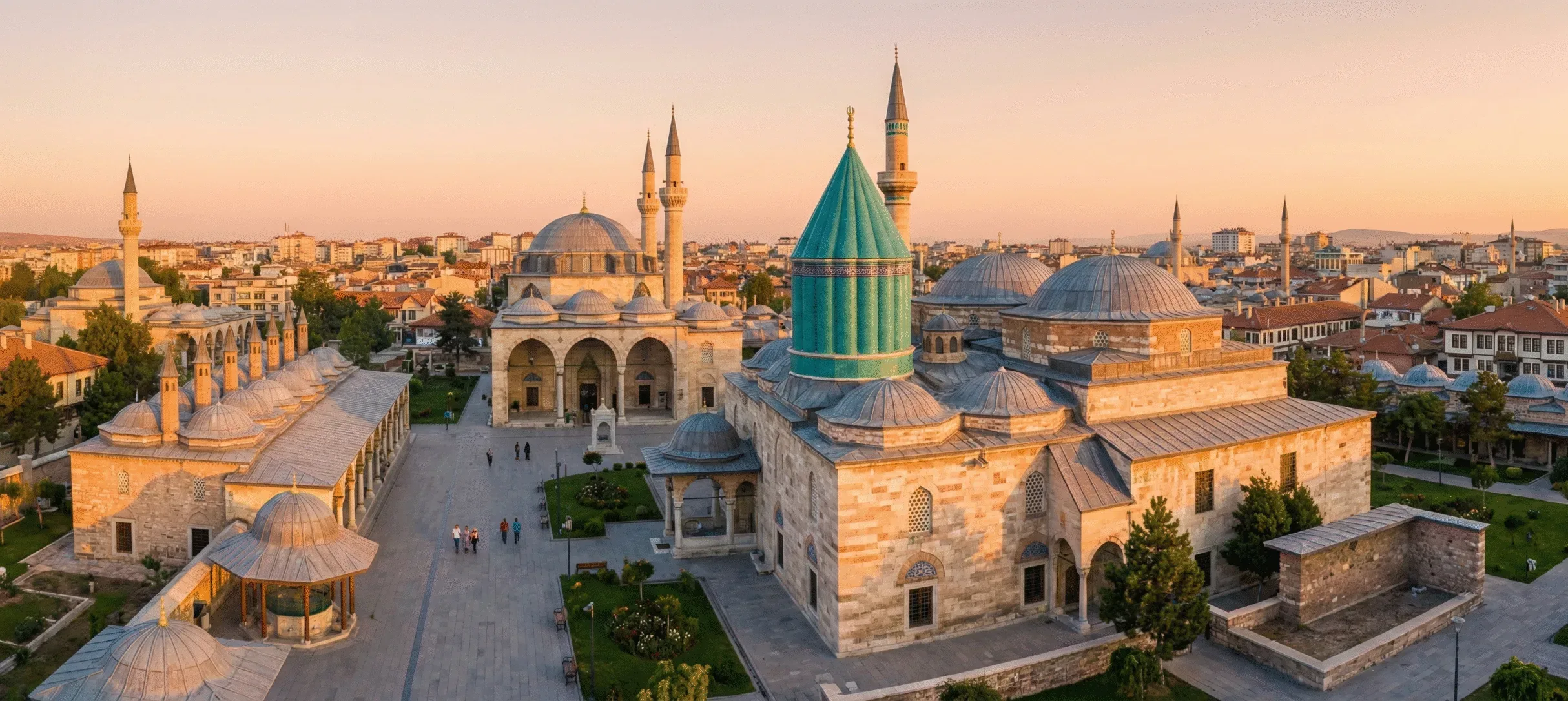 Sunrise view of the Mevlana Museum complex in Konya, highlighting the iconic turquoise dome and Selimiye Mosque.