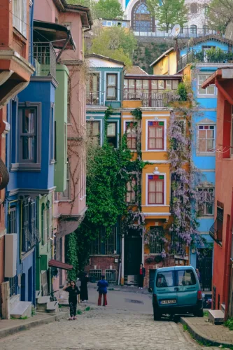 A vibrant photo of the famous colorful wooden houses and historic, narrow streets in the Balat neighborhood of Istanbul.