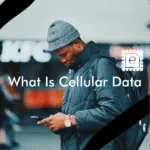 A person in the middle of the street using his phone with cellular data