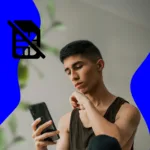 Visual representation of a person looking annoyed at his phone for not working properly